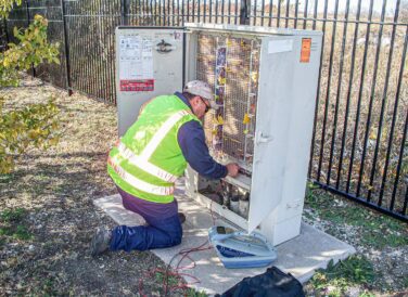 SUE crew member working on electrical box wiring system